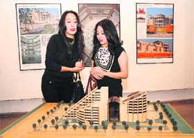 Visitors admire a model of a building designed by Raj Rewal