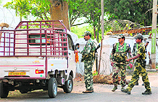 CRPF soldiers inspect a vehicle on a road adjoining the Gajalbadi forest in Odishas Kandhamal district; and (right) a file photo of Paolo Bosusco with a tribal child. 