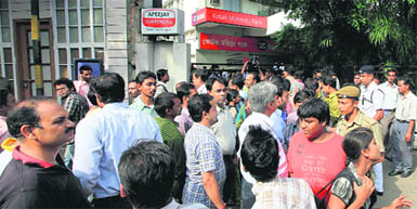 Employees evacuate their office building following tremors in Kolkata. 