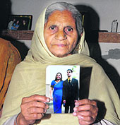 Grandmother shows the photo of the deceased Rahul Sharma at Avtar Nagar in Jalandhar.