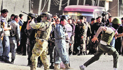 A NATO soldier takes up position near a site of attack in Kabul on Sunday.