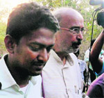 Sukma Collector Alex Paul Menon (L) comes out from forest with mediator BD Sharma after being released by Maoists at Tadmetla in Chhattisgarh