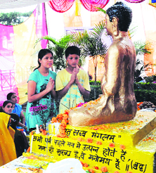 People pay obeisance at the statue of Lord Buddha on the occasion of Buddha Purnima in Dehradun on Sunday