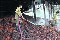  Firemen douse the fire at Jammus Narwal Mandi on Wednesday. 