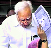 A member waves a photocopy of the cartoon as Kapil Sibal speaks in Lok Sabha on Friday