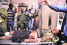A wounded policeman is carried on a stretcher into a hospital in Srinagar on Saturday.