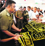 BSF officers place a chaddar offered by Pak Rangers at Baba Daleep Singh Manhass shrine at Chamliyal. 