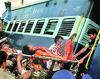 An injured passenger being taken out from the Hampi Express that smashed into a stationary goods train in Anantapur district of Andhra Pradesh.