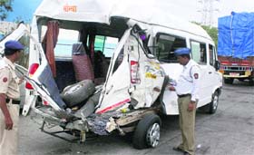 Police personnel inspect the ill-fated vehicle