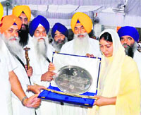 Bibi Kamaldeep Kaur, sister of Balwant Singh Rajoana, receives the title of Zinda Shaheed on behalf of her brother from the Sikh high priests at Akal Takht in Amritsar on Wednesday.