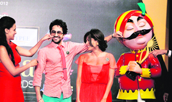 Bollywood actress Neha Dhupiya (L) touches the face of actor Ayushman Khurana as actress Chitrangada Singh (R) looks on, while they pose with an Air India "Maharaja" mascot during the opening news conference of the 13th International Indian Film Academy (IIFA) Awards in Singapore recently.