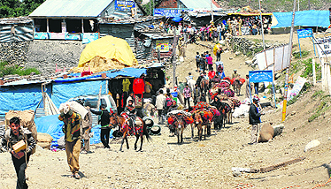 Porters carrying essential supplies leave for the holy cave shrine through the Chandanwari route as the Amarnath Yatra begins at Jammu. The first batch comprising 2,294 pilgrims was flagged off on Sunday.