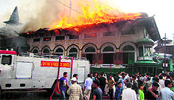 Firefighters try to douse the fire that broke out at the Pir Dastageer Sahab shrine in Srinagar on Monday