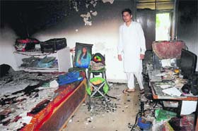 A man inside his gutted house at Sector 37 in Chandigarh where a fire broke out on Saturday