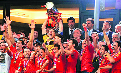 Spanish players celebrate with the trophy after winning the Euro 2012 football championships final against Italy in Kiev on Sunday. 