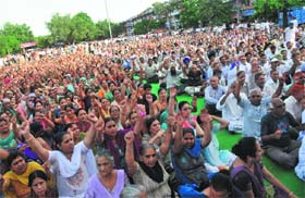 Members of the Chandigarh Housing Board Resident Federation during a rally at Sector 40 in Chandigarh on Sunday