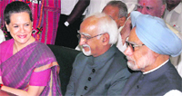 Hamid Ansari, flanked by PM Manmohan Singh and UPA chairperson Sonia Gandhi, files his nomination papers in New Delhi on Wednesday.  PTI