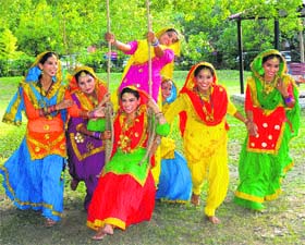 Girls enjoy swings at the Dehlia Garden in Sector 36 of Chandigarh on Saturday