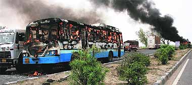 A Haryana Roadways bus that was torched by a mob in Rewari on Sunday. 