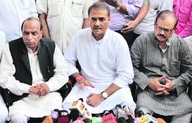 NCP leader Praful Patel (C) addresses a press conference in New Delhi on Monday
