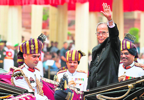 President Pranab Mukherjee waves from his horse-drawn carriage at Rashtrapati Bhawan after his swearing-in ceremony on Wednesday.