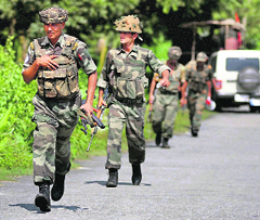 Armymen from the Dogra Regiment move into position to nab rioters in Chirang district on Wednesday.