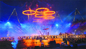Artistes perform as the Olympic rings are pictured above the stadium during the opening ceremony of the London 2012 Olympic Games on Friday.  AFP