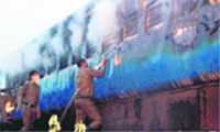 Fire personnel douse the fire that broke out in a coach of the Chennai-bound Tamil Nadu Express.  PTI 