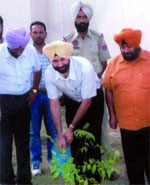 SSP Dr SS Gill plants a sapling at the Civil Lines police station.