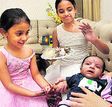 Girls tie rakhi on their 45-day-old brother at Sector 15, Chandigarh, on Thursday