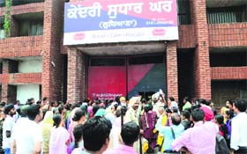 Women wait at the gate of the Central Jail in Ludhiana on Thursday