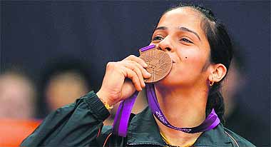 Saina Nehwal kisses her bronze medal after China's Wang Xin retired hurt in the third-place play-off match in women's singles badminton at the London Olympic Games.