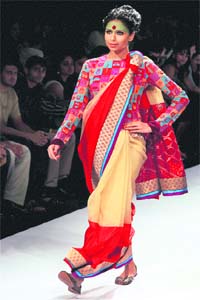 Gold and beautiful: A model displays a creation of designer Deepika Govind during Lakme Fashion Week 2012 in Mumbai. — PTI