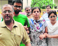 Geetika Sharmas family members come out of a New Delhi court on Thursday. 