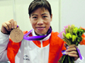 Indias Mary Kom with her bronze medal in boxing, on Thursday.