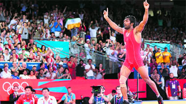 Yogeshwar Dutt celebrates after defeating North Koreas Ri Jong Myong in the mens 60kg freestyle bronze medal match on Saturday in London.