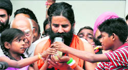 Baba Ramdev being offered fruit juice to end his fast in New Delhi on Tuesday.