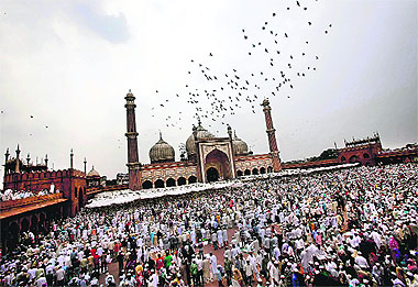 Muslims congregate after offering prayers at the Jama Masjid ahead of Eid-ul-Fitr in the old quarters of Delhi. Eid-ul-Fitr marks the end of Ramadan, the holiest month in the Islamic calendar.