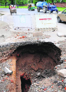 The portion of a road near St John’s School that caved in after the rain on Monday.
