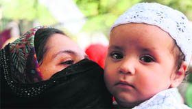 A child accompanies his mother to a mosque.