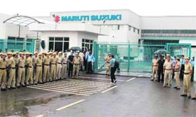 Policemen and MSIL security personnel guard the companys Manesar plant which reopened after a month-long lockout on Tuesday