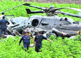 IAF personnel near the debris of one of the helicopters involved in Thursdays crash