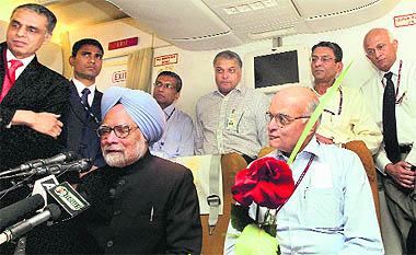 Prime Minister Manmohan Singh, with NSA Shivshankar Menon, addresses the media on board his special flight to Delhi after attending the NAM Summit in Tehran.