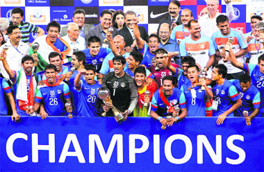 The Indian team celebrates with the winning trophy after defeating Cameroon vie a tie-breaker by 7-6 in the Nehru Cup final match in New Delhi on Sunday