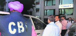 CBI officials leave after conducting a raid in New Delhi.