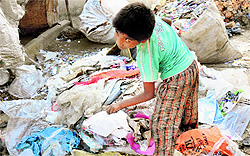 Rohit, a class IV dropout, picks rags to support his family in Karnal district on Friday