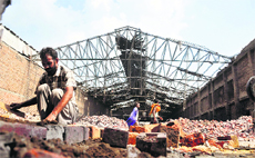 Repair work goes on at the fire accident site in Khanna on Thursday.