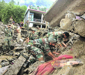 Army personnel perform rescue work after many homes were washed away by heavy rains and flash floods at a village in Ukhimath, Rudraprayag district, on Friday. 