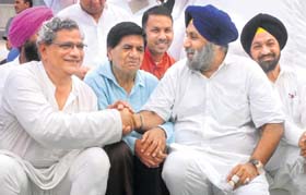 Punjab Deputy Chief Minister Sukhbir Singh Badal and CPM general secretary Sitaram Yechury at Bandala village in Jalandhar district on Sunday