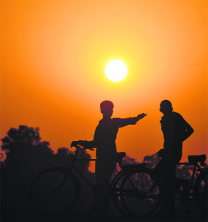 Workers return home after a hard day’s work in Ludhiana on Wednesday.